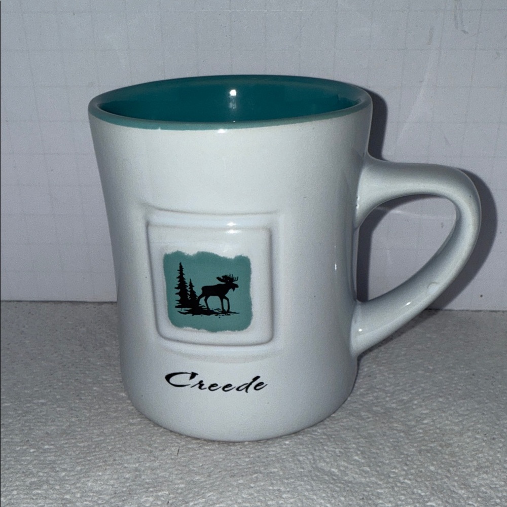 Creed Ceramic Moose Mug with White and Teal Design